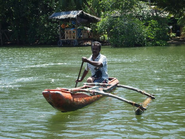 riding traditional boats in madu river